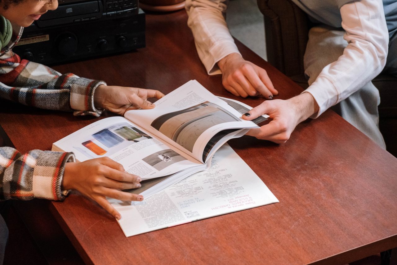 Colleagues reviewing printed layouts
