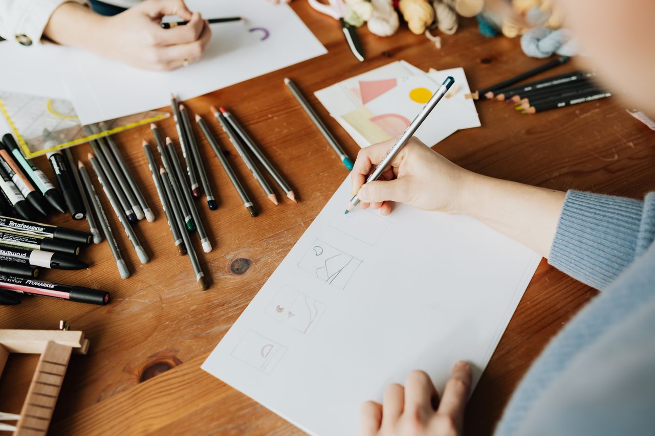A designer sketching at a desk