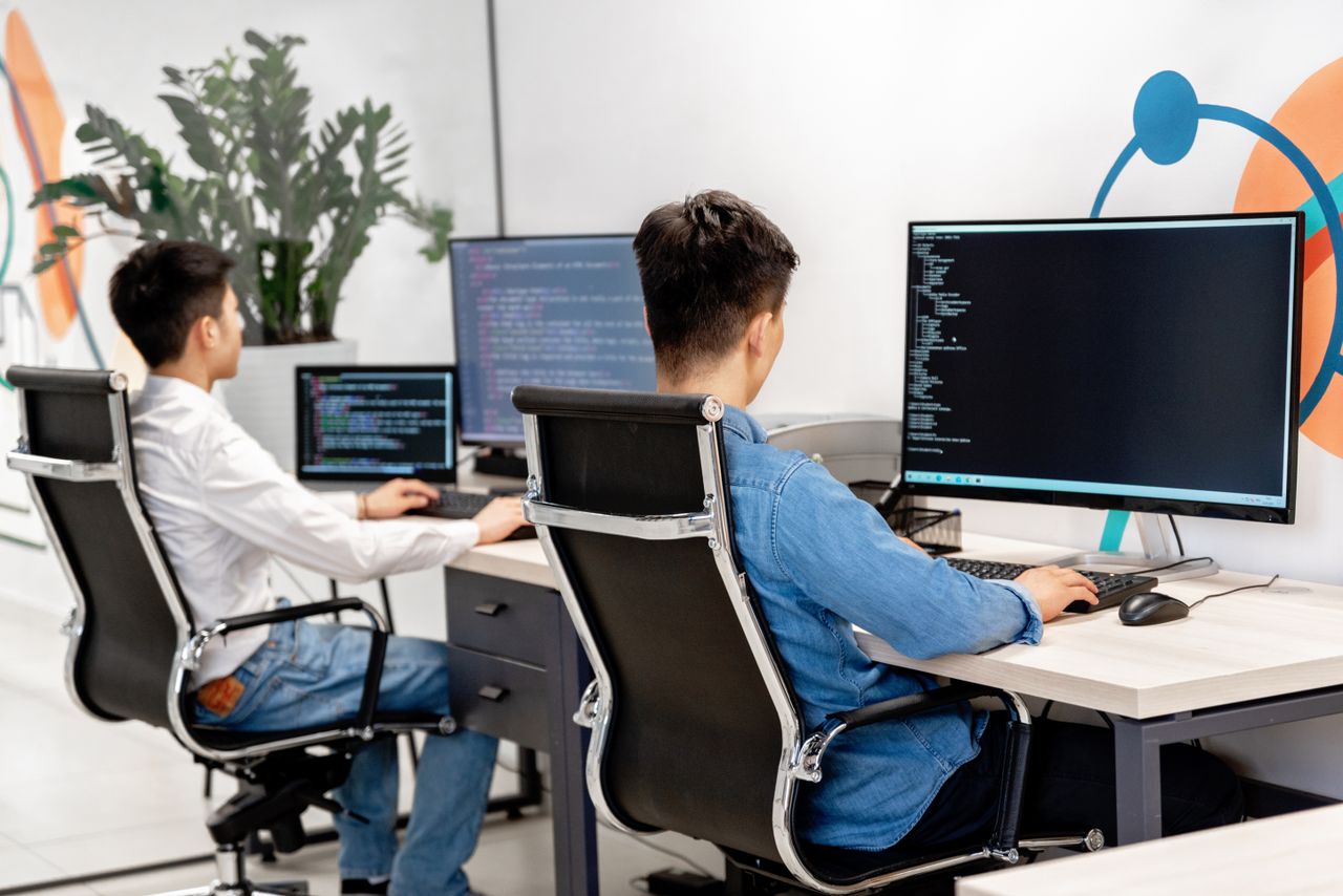 A developer working at a large monitor